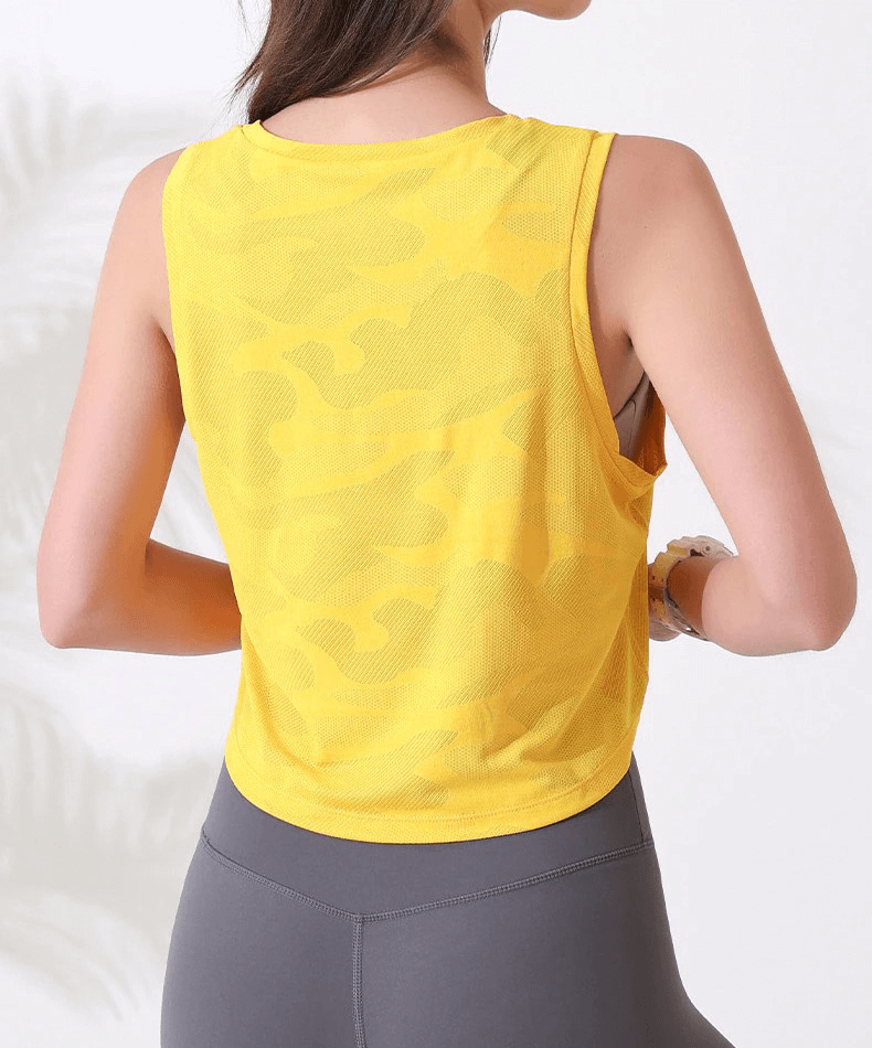 Back view of a woman wearing a yellow camouflage breathable crop top, ideal for yoga and running sessions.